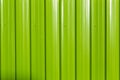 Green metal sheet fence in bright day light Royalty Free Stock Photo