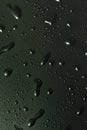 Black metal water drops on dark reflective surface Royalty Free Stock Photo