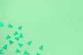 green metallic foil christmas trees and stars confetti sparse on trendy neo mint colored background