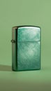 Green metallic lighter on green background, close-up view. Modern design and minimalist concept Royalty Free Stock Photo