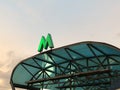 Green metro sign on the visor of entrance