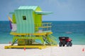 Green Miami Beach lifeguard tower with ocean view in background