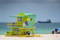 Green Miami Beach lifeguard tower with ocean view in background