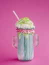 Green milkshake on pink background Photo