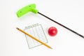 Green mini golf club with score card and ball Royalty Free Stock Photo