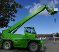 Green mobil crane with boom, hook and sling