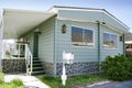 Green Mobile Home on a Sunny Day - Rehabbed Unit - Double Wide - Real Estate Investment - Mobile Home Park