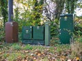 Green mobile phone network infrastructure cabinets at the roadside in a rural location Royalty Free Stock Photo