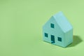 Green model house on a matching background for eco housing Royalty Free Stock Photo