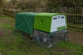 A green modern bright looking chicken coup or hen house with covered top