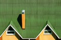 Green modern corner roofing construction from texture corrugated metal with dormer windows and smokestack Royalty Free Stock Photo