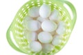 Green modern plastic basket full of white chicken eggs Royalty Free Stock Photo