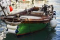 Green moored fishing boat with fenders