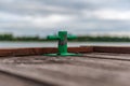 Green mooring handle on the old wooden pier