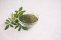 Green moringa leaf powder. Moringa leaf tea. green powder on white background Royalty Free Stock Photo