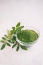 Green moringa leaf powder. Moringa leaf tea. green powder on white background Royalty Free Stock Photo