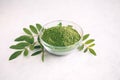 Green moringa leaf powder. Moringa leaf tea. green powder on white background Royalty Free Stock Photo