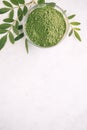 Green moringa leaf powder. Moringa leaf tea. green powder on white background Royalty Free Stock Photo