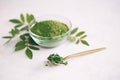 Green moringa leaf powder. Moringa leaf tea. green powder on white background Royalty Free Stock Photo