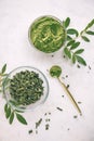 Green moringa leaf powder. Moringa leaf tea. green powder on white background
