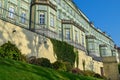 Green moss on an old fence with an ancient building under the sun Royalty Free Stock Photo