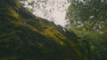 Green moss on rocky hill. Action. Beautiful cover of moss on rocky areas in green park. Green moss on background of