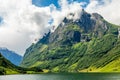 Green mountain peak above the small village in Naeroy fjord,  Aurlan, Sogn og Fjordane county, Norway Royalty Free Stock Photo