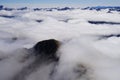 Green mountain peak surrounded by clouds - Doubtful Sound