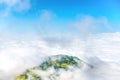 Green mountain peak in white clouds Royalty Free Stock Photo