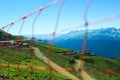 Green mountain range with a cable car against the backdrop of mountains and a red grid in front Royalty Free Stock Photo