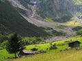 Green mountain valley with huts summer season alpine landscape Royalty Free Stock Photo