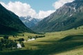 Green mountain valley landscape with blue sky and white clouds. Deep shadows lies on a meadow Royalty Free Stock Photo