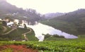 Green mountains and lake near a village Royalty Free Stock Photo