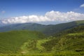 Green mountains panorama under blue sky on bright sunny day. Tourism and traveling concept, copy space background Royalty Free Stock Photo