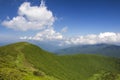 Green mountains panorama under blue sky on bright sunny day. Tourism and traveling concept, copy space background Royalty Free Stock Photo