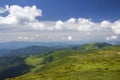 Green mountains panorama under blue sky on bright sunny day. Tourism and traveling concept, copy space background Royalty Free Stock Photo