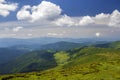 Green mountains panorama under blue sky on bright sunny day. Tourism and traveling concept, copy space background Royalty Free Stock Photo