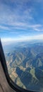 Green mountains seen from the airplane window Royalty Free Stock Photo
