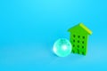 Green multi-storey residential building and blue earth globe. Green technologies. Environmentally friendly, energy efficiency Royalty Free Stock Photo