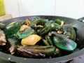 Green mussels and batik clams cooked in tomato sauce, soy sauce and oyster sauce. Simple home cooking.