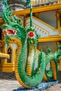 Green naka statue in front of Thai Buddhist pagoda at Tiger Cave