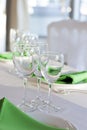 Green napkins lies on a white plate. Served table for the holiday. Royalty Free Stock Photo