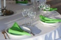 Green napkins lies on a white plate. Served table for the holiday. Royalty Free Stock Photo