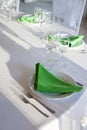 Green napkins lies on a white plate. Served table for the holiday. Royalty Free Stock Photo