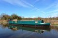 Green narrow boat on Lancaster canal near Galgate