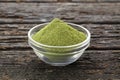 Green and natural moringa powder in a bowl - Moringa oleifera Royalty Free Stock Photo