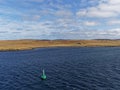 A Green Navigation Buoy with a solar Panel in the Shetland Sound