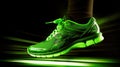 Green neon sneakers on a black background with copy space for text or design. A close up of a pair of walking shoes. Fashion Royalty Free Stock Photo