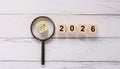 Green Net Zero Icon Under Magnifying Glass with Wooden Blocks Showing 2026 Royalty Free Stock Photo