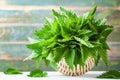 Green nettle leaves in basket on wooden rustic background, stinging nettles, urtica Royalty Free Stock Photo